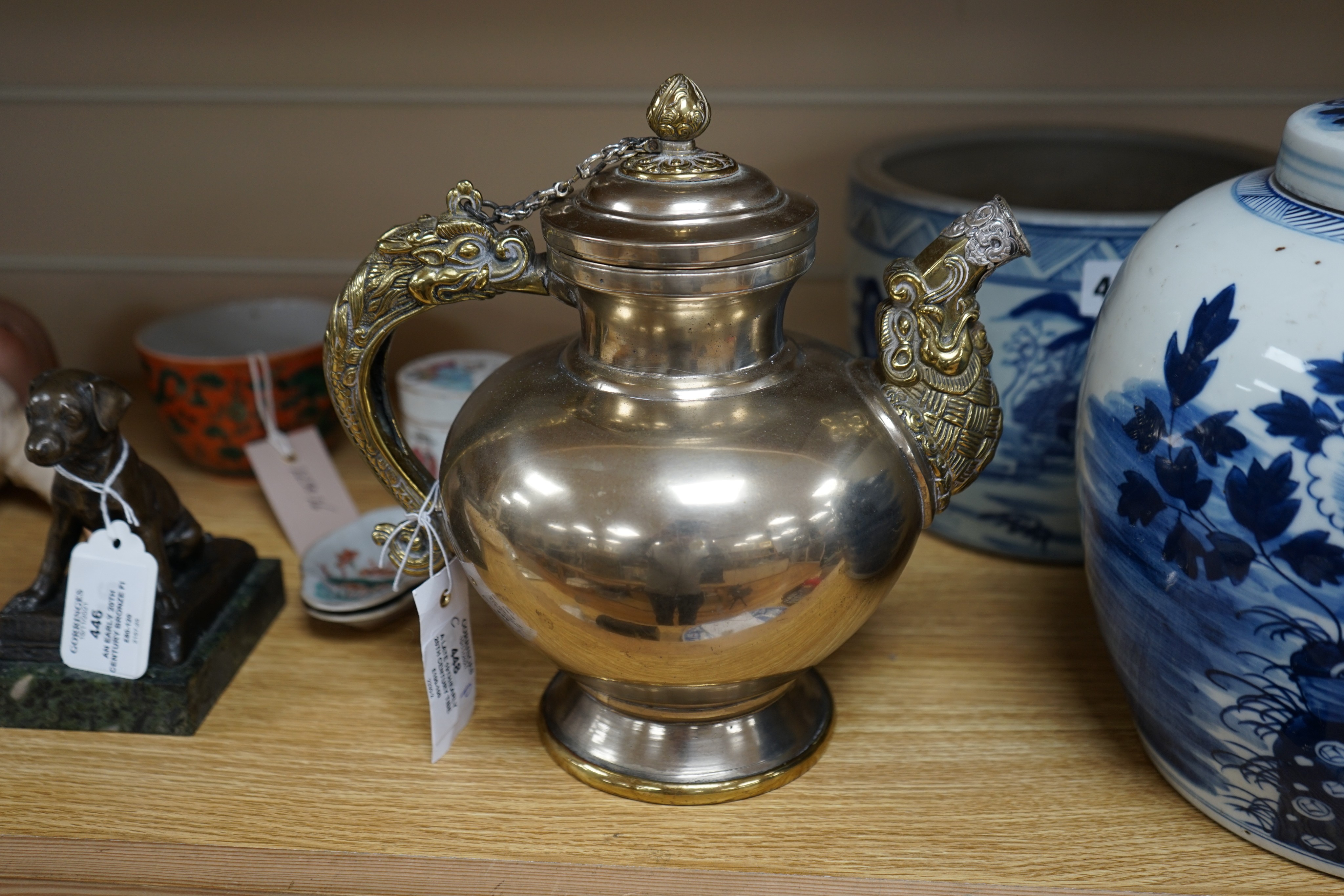 A late 19th/early 20th century Tibetan paktong, bronze and silver mounted teapot, 24cm